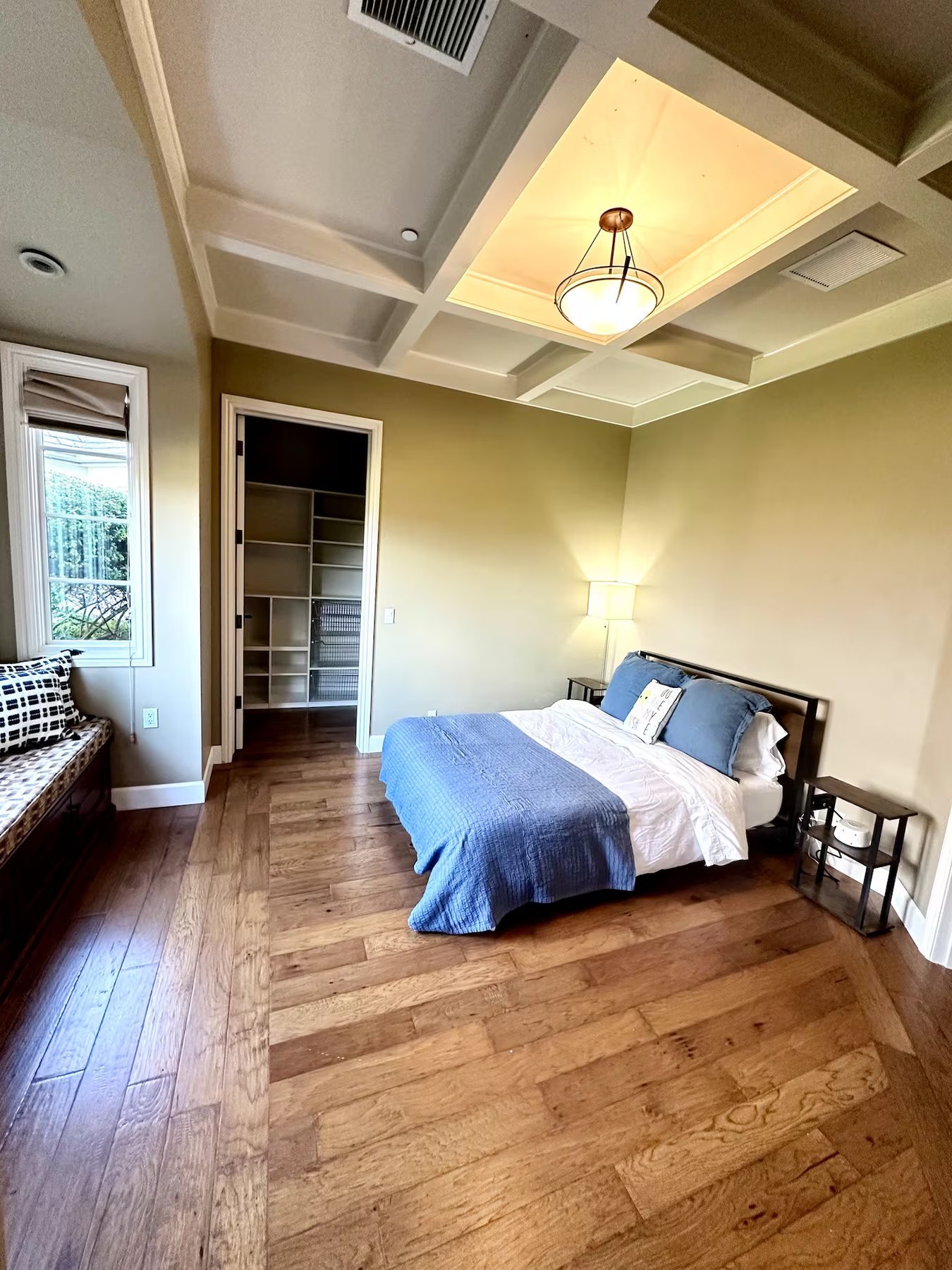 The Garden Room with green walls and a walk-in closet