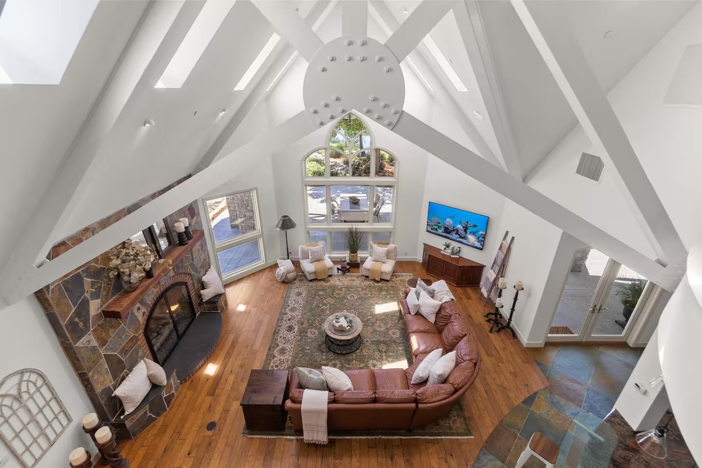 The great room with vaulted beams and a stone fireplace