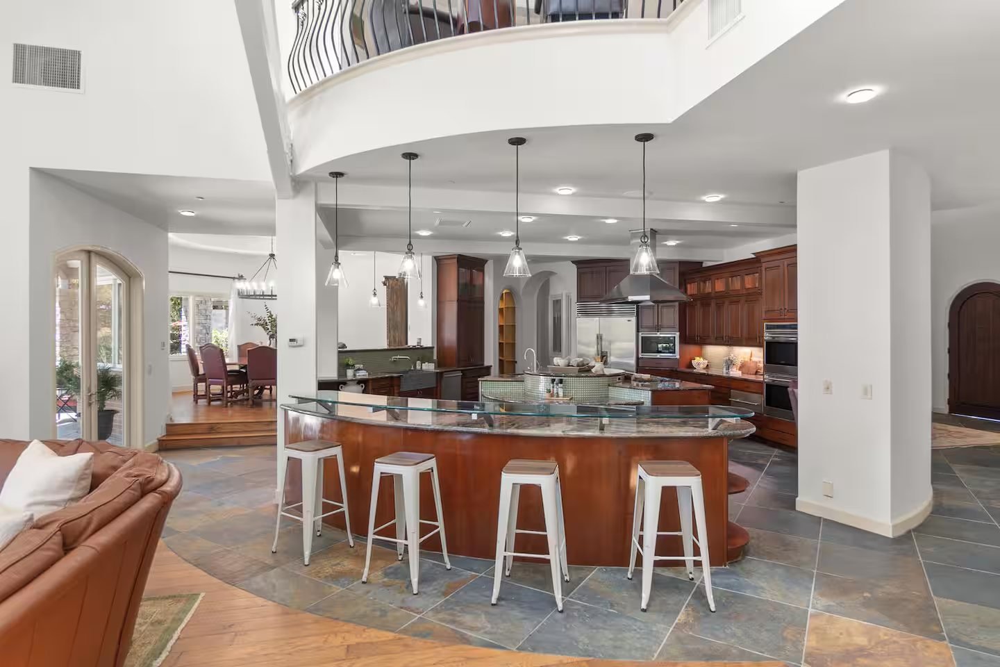 The kitchen with its island and pendant lights