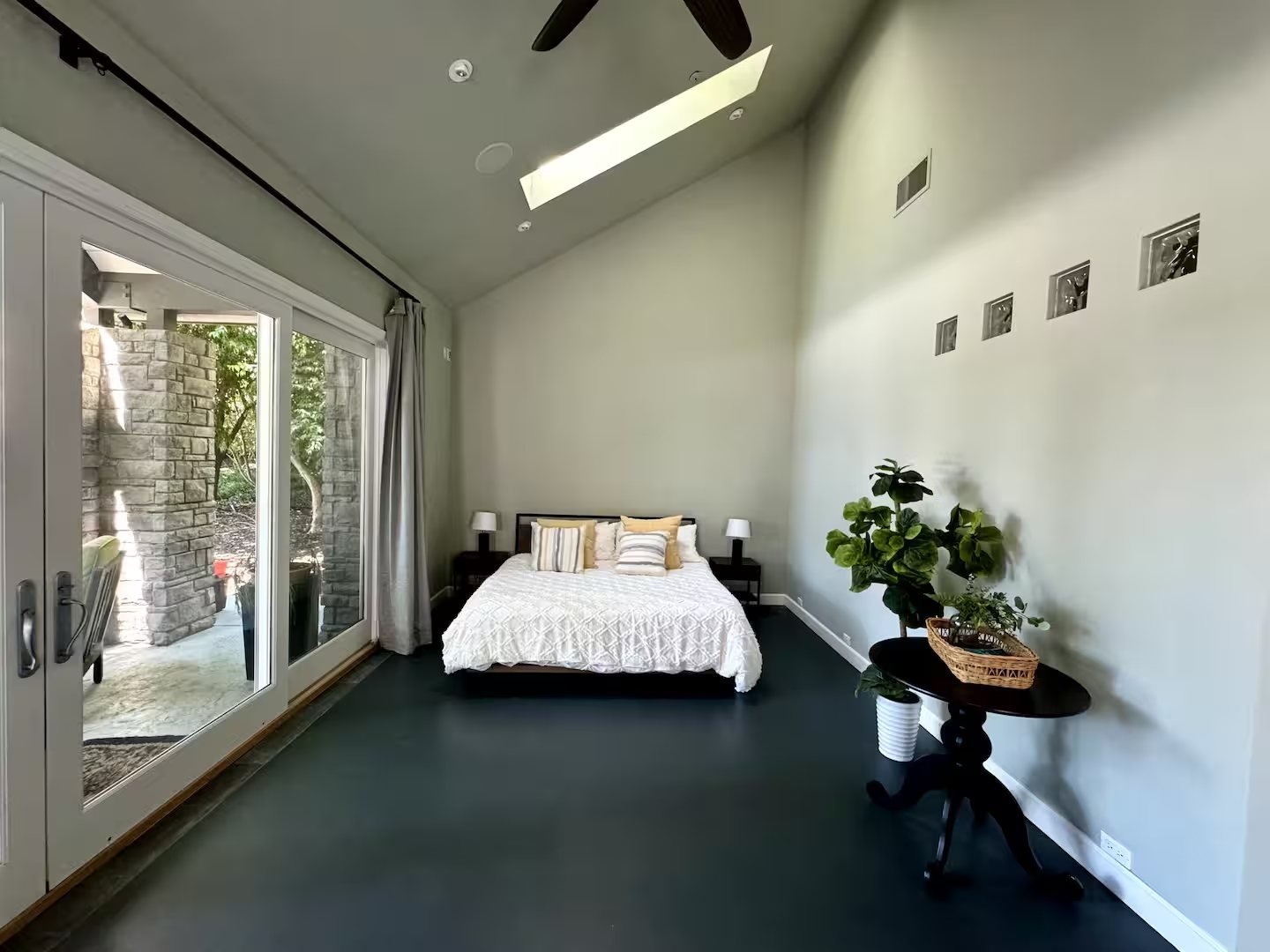 The studio with a king bed, vaulted ceiling and sliding doors to the patio