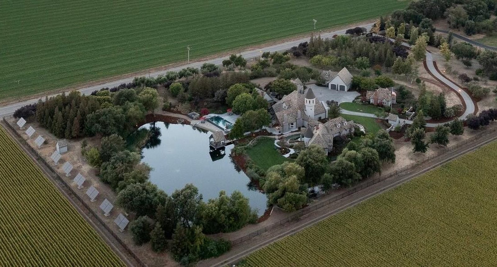 Aerial view of the estate at sunset, showing the castle, the Fairytale Retreat and the Lake Cottage